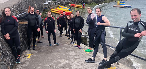 Medical colleagues in wetsuits after kayaking Medical colleagues in wetsuits after kayaking